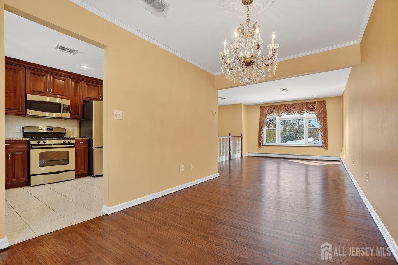 1 Wakefield Drive Edison, NJ 08820 - Photo 7 of 29 a view of an empty room with a window and wooden floor