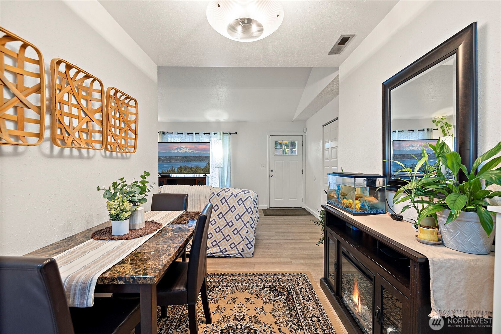 19401 Southeast 267th Street Covington, WA 98042 - Photo 12 of 31 a view of a dining room with furniture and a potted plant