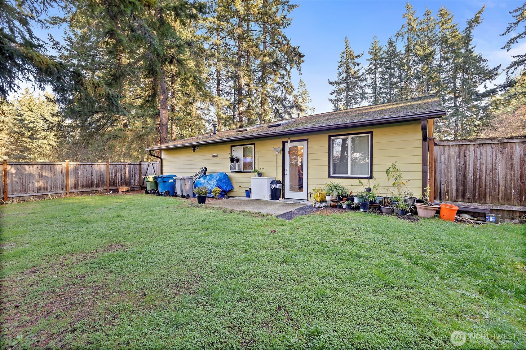 19401 Southeast 267th Street Covington, WA 98042 - Photo 22 of 31 a view of a backyard with table and chairs and a large tree