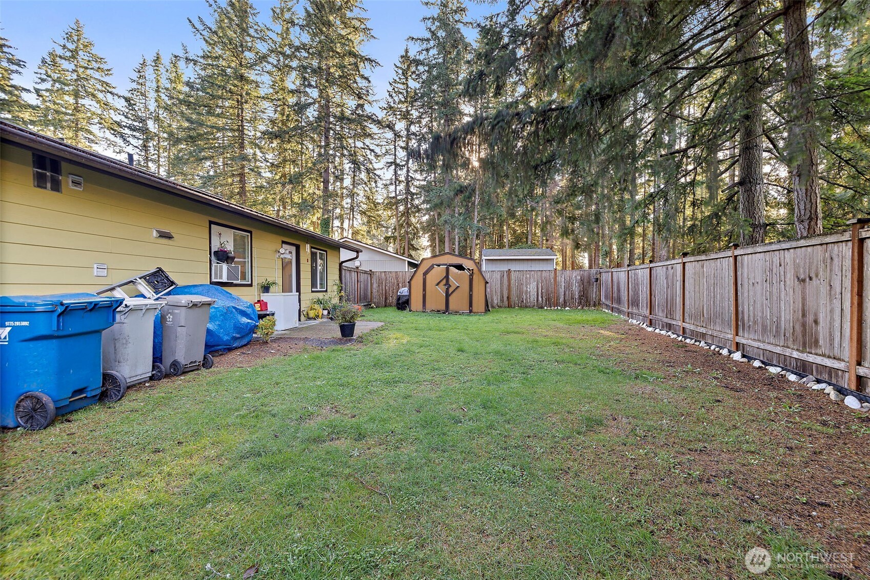 19401 Southeast 267th Street Covington, WA 98042 - Photo 24 of 31 a view of a backyard with table and chairs and a large tree