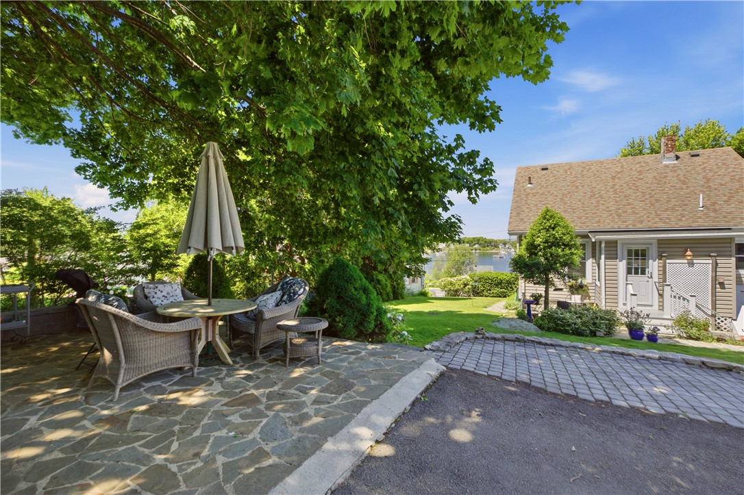 1536 Main Road Tiverton, RI 02878 - Photo 29 of 34 Backyard offers landscaped stonewalls and path, mature perennial gardens, plenty of shade and sunlight, large parking area and a slate patio