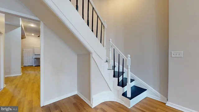 a view of entryway and hall with wooden floor