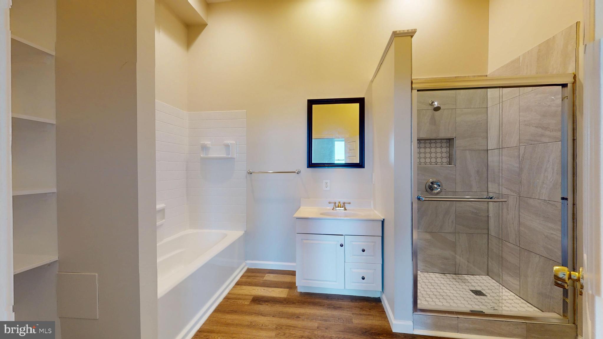 708 North Gilmor Street Baltimore, MD 21217 - Photo 16 of 35 a bathroom with a bathtub and a shower