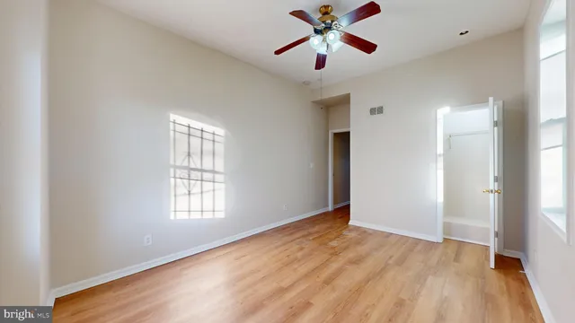 wooden floor in an empty room with a window
