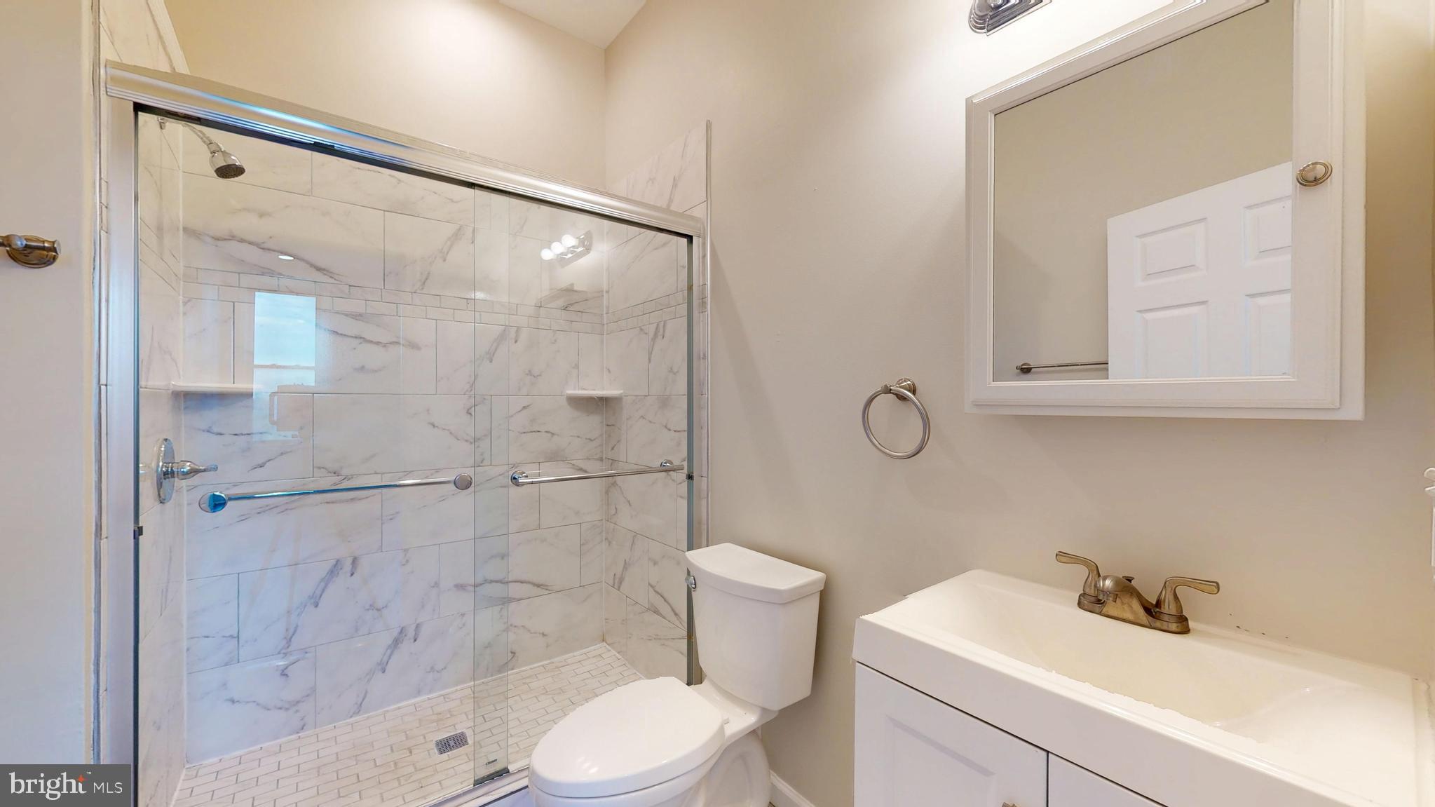 708 North Gilmor Street Baltimore, MD 21217 - Photo 26 of 35 a bathroom with a sink toilet and shower