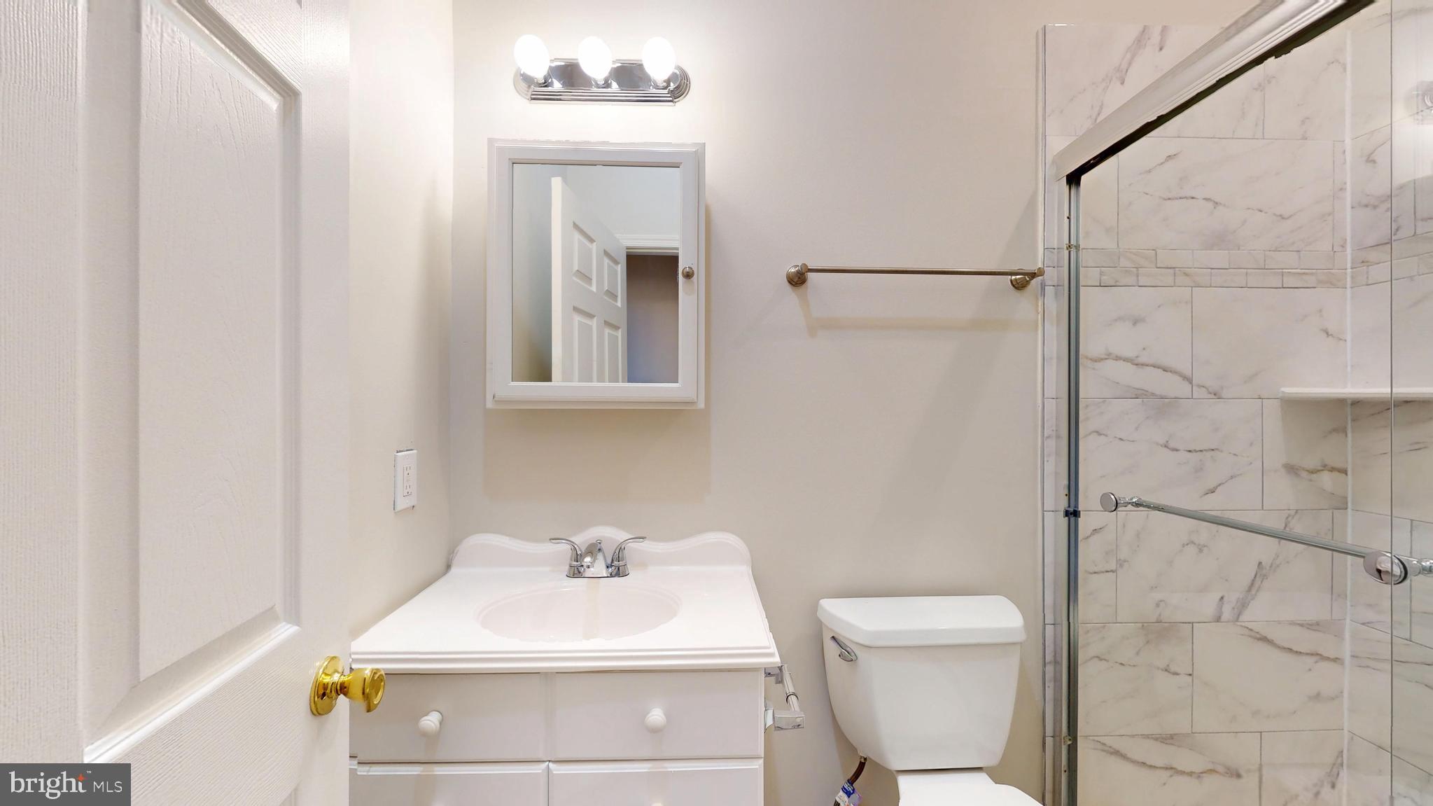 708 North Gilmor Street Baltimore, MD 21217 - Photo 27 of 35 a bathroom with a sink toilet and shower