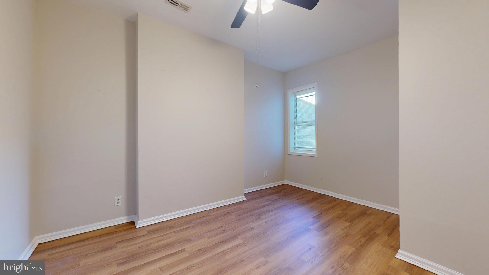 708 North Gilmor Street Baltimore, MD 21217 - Photo 29 of 35 a view of an empty room with wooden floor and a window