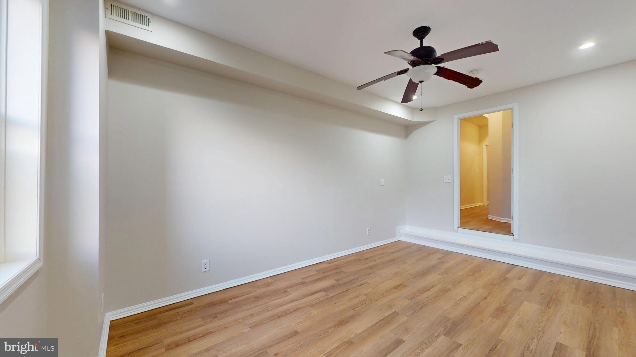708 North Gilmor Street Baltimore, MD 21217 - Photo 31 of 35 a view of empty room with wooden floor and fan