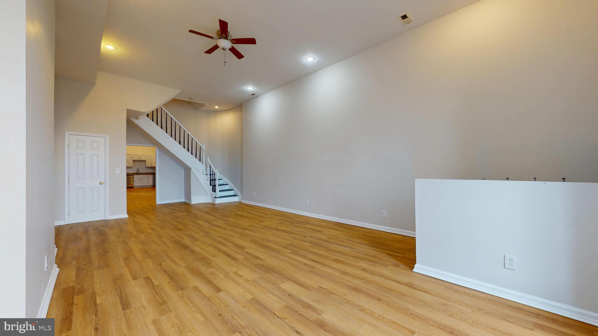 708 North Gilmor Street Baltimore, MD 21217 - Photo 9 of 35 a view of a big room with wooden floor and ceiling fan