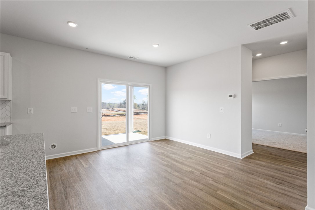 135 Cedar Shoals Easley, SC 29640 - Photo 12 of 37 This bright interior features wood flooring, recessed lighting, and sliding glass doors to the exterior.