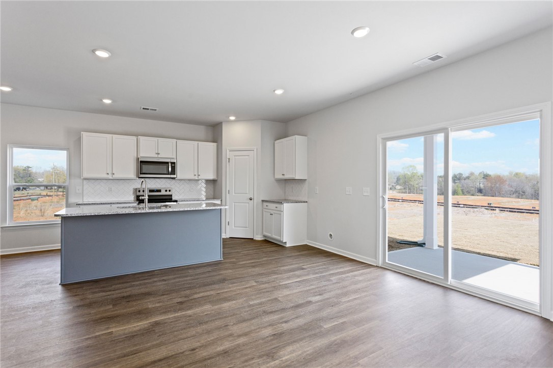 135 Cedar Shoals Easley, SC 29640 - Photo 13 of 37 This bright kitchen features a spacious island and easy access to outdoor living.