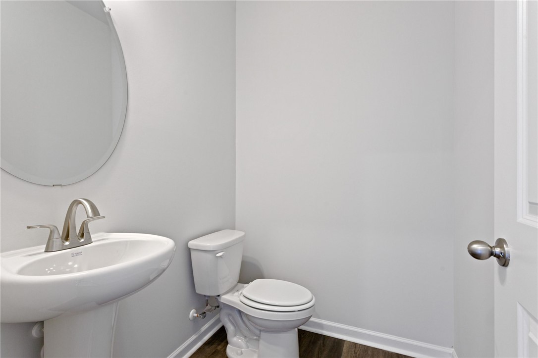 135 Cedar Shoals Easley, SC 29640 - Photo 14 of 37 This bathroom features a contemporary pedestal sink and toilet, perfect for daily routines.