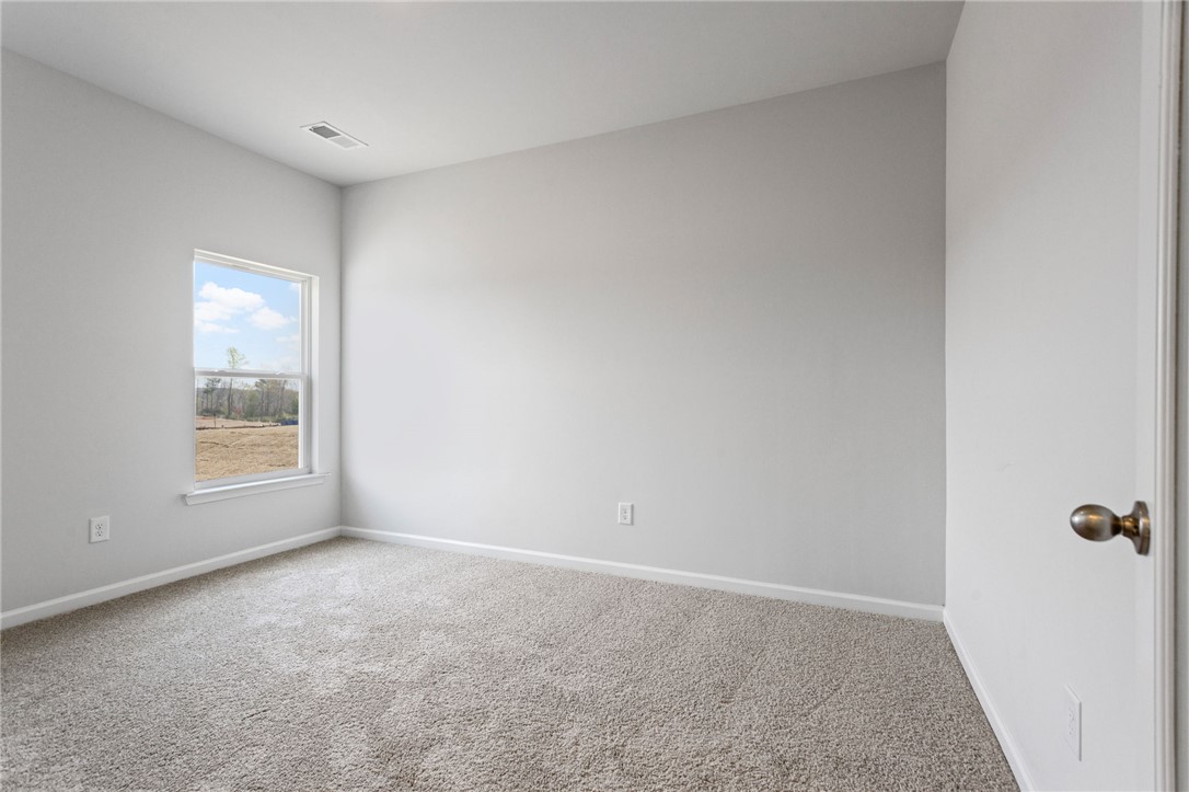 135 Cedar Shoals Easley, SC 29640 - Photo 15 of 37 This bright and airy room offers a comfortable and inviting atmosphere, perfect for rest and relaxation.