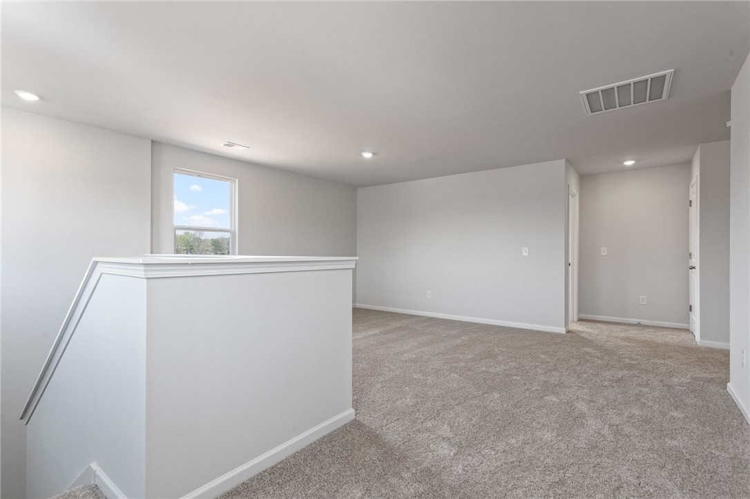 135 Cedar Shoals Easley, SC 29640 - Photo 17 of 37 This bright and open loft area offers versatile living space with plush carpet flooring.