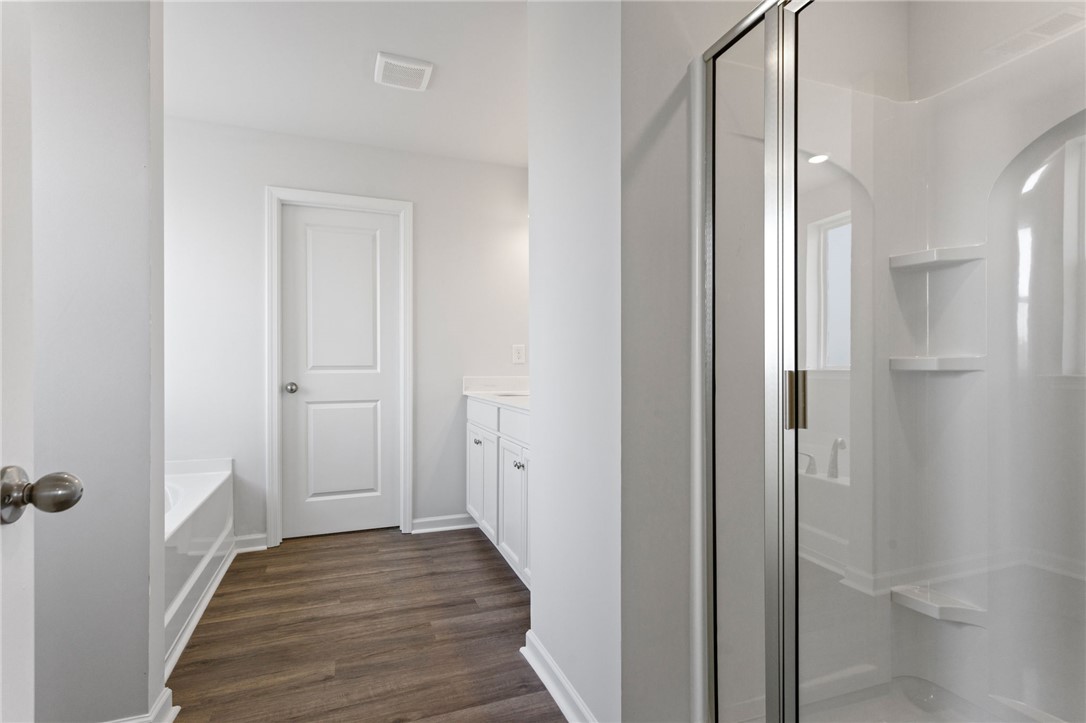135 Cedar Shoals Easley, SC 29640 - Photo 22 of 37 This clean and bright bathroom features elegant flooring and a spacious shower for ultimate comfort.