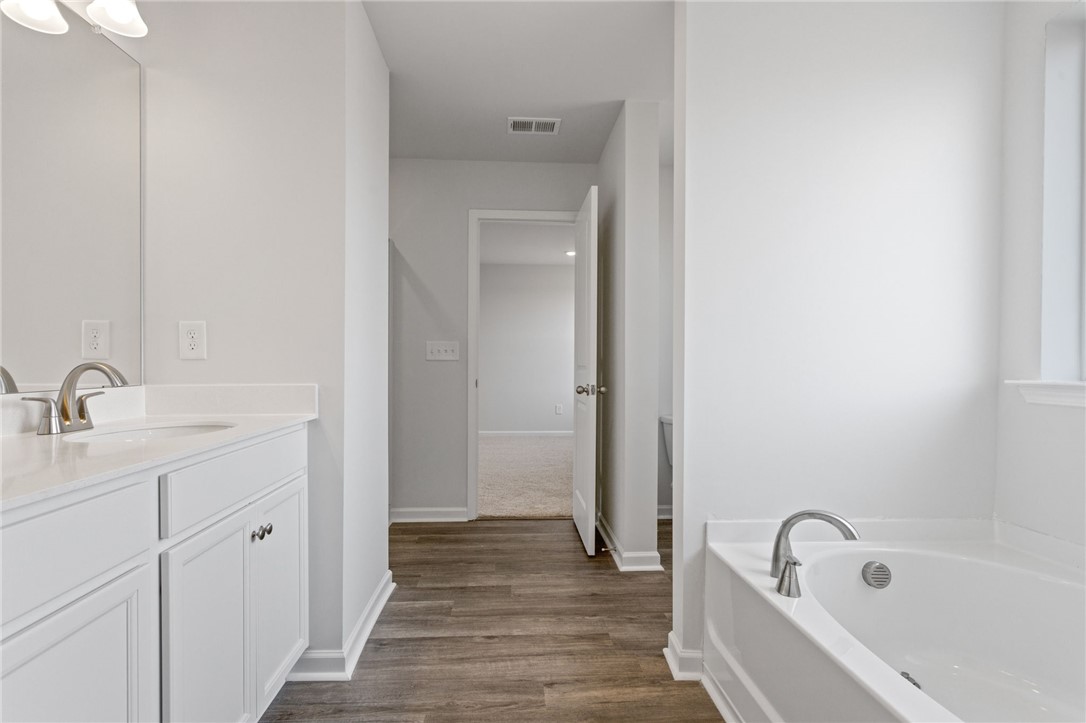 135 Cedar Shoals Easley, SC 29640 - Photo 23 of 37 This primary bathroom features a double vanity and a soaking tub for ultimate relaxation.