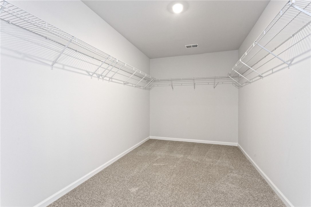 135 Cedar Shoals Easley, SC 29640 - Photo 24 of 37 This spacious closet offers ample storage and organization for a streamlined living.