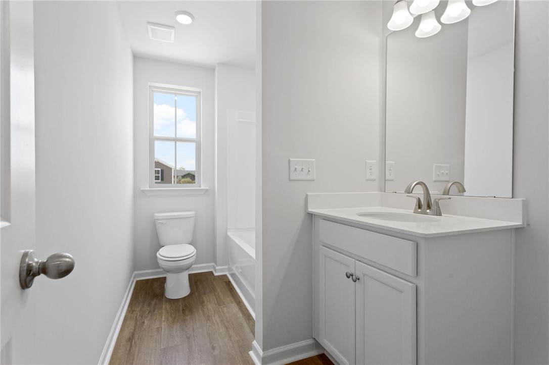 135 Cedar Shoals Easley, SC 29640 - Photo 25 of 37 This modern bathroom features a sleek vanity and a window for natural light.