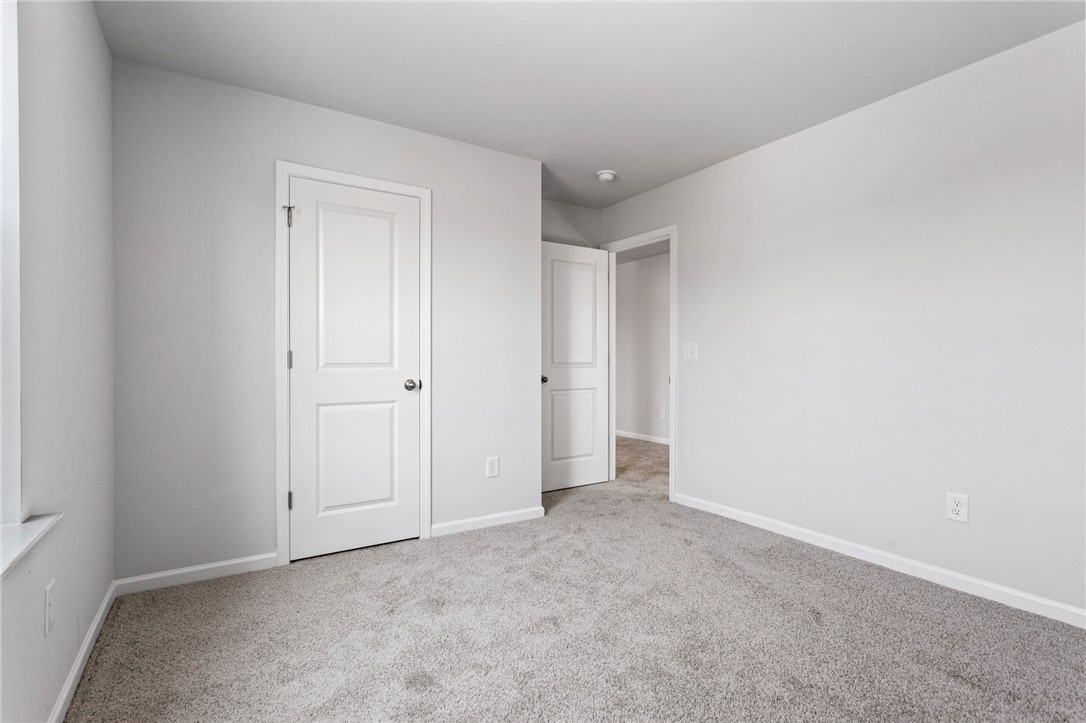 135 Cedar Shoals Easley, SC 29640 - Photo 27 of 37 This spacious room offers plush carpet flooring, ample natural light, and classic paneled doors.