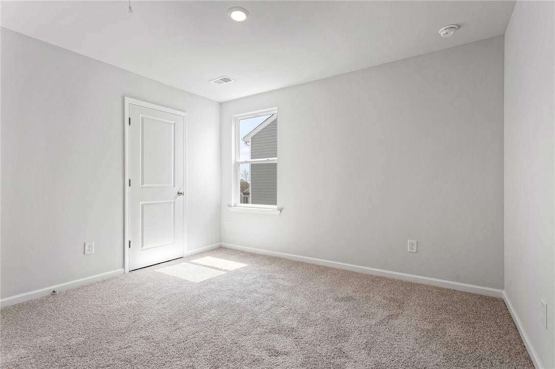 135 Cedar Shoals Easley, SC 29640 - Photo 28 of 37 This bright and airy room offers a fresh canvas for comfortable living.