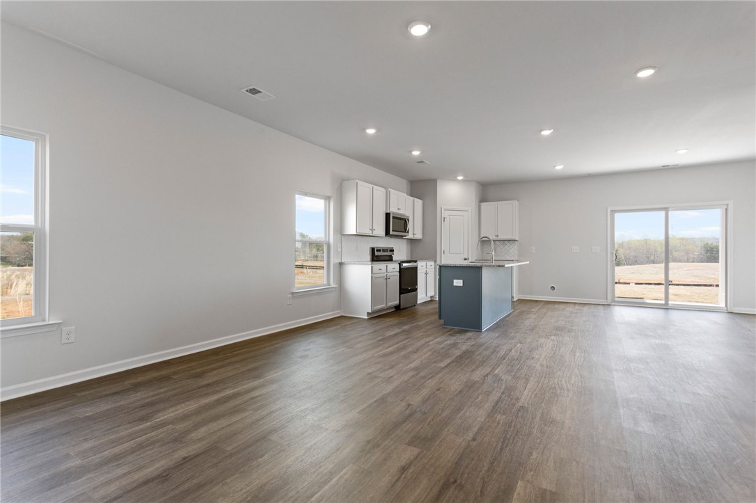 135 Cedar Shoals Easley, SC 29640 - Photo 6 of 37 This luminous space seamlessly blends living and culinary areas, perfect for contemporary living.