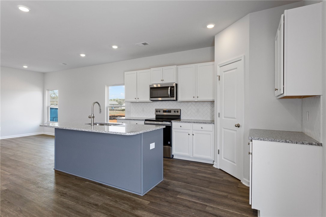 135 Cedar Shoals Easley, SC 29640 - Photo 10 of 37 This bright kitchen features sleek appliances and ample counter space, perfect for culinary endeavors.