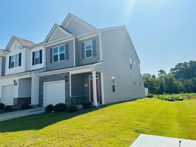 a view of a house with pool and a yard