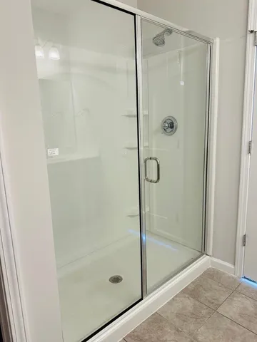 a bathroom with a glass shower door