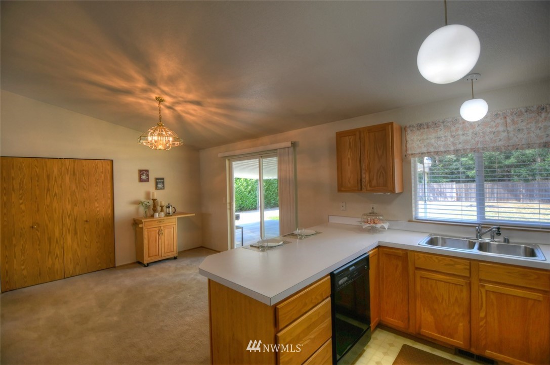 5436 187th Court Southwest Rochester, WA 98579 - Photo 11 of 25 a kitchen with a stove a sink and a refrigerator