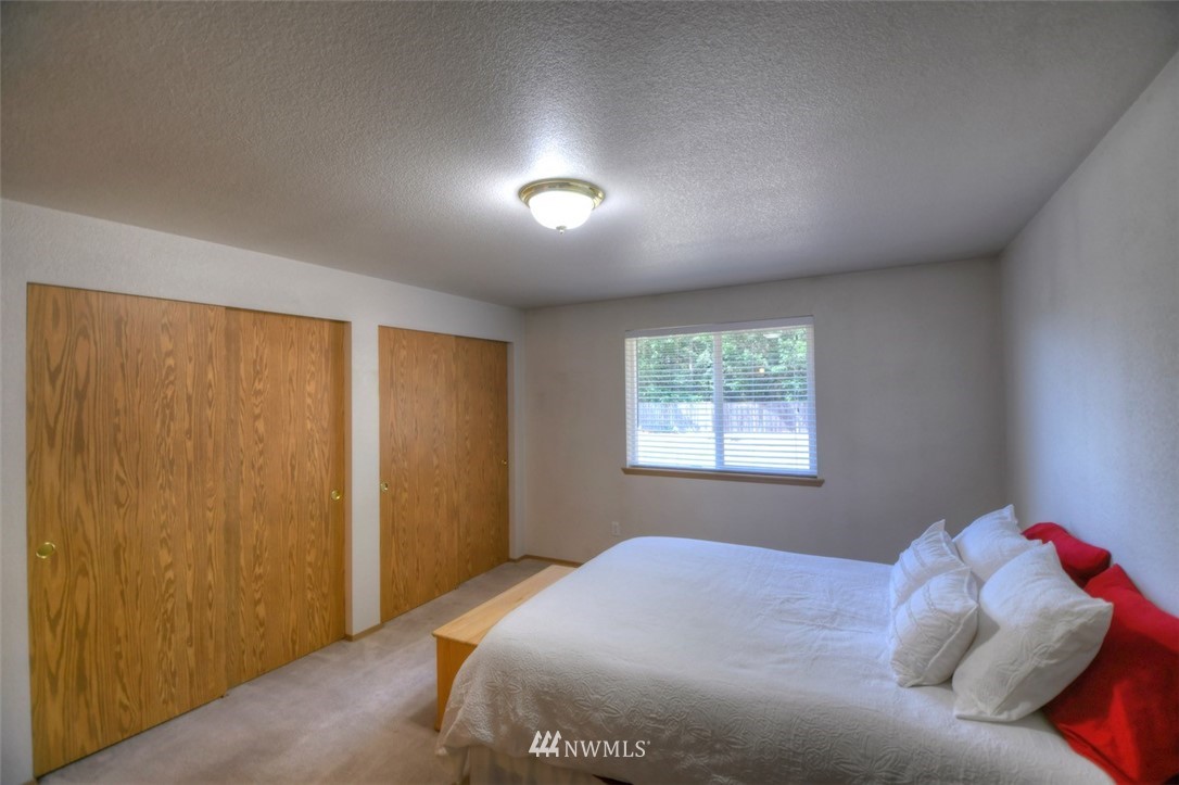 5436 187th Court Southwest Rochester, WA 98579 - Photo 12 of 25 a bedroom with a bed and a window