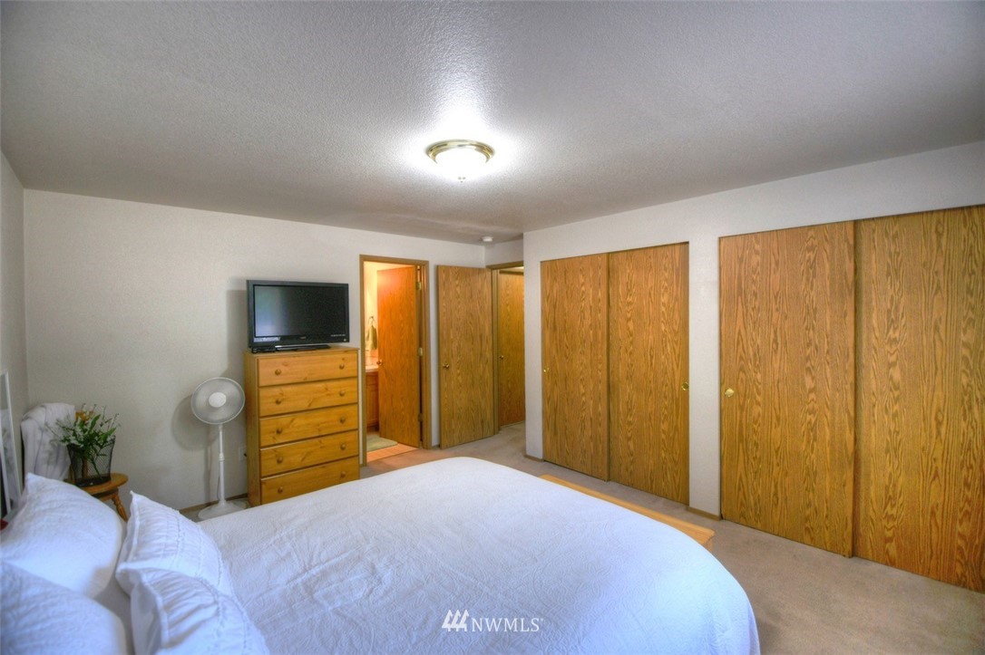 5436 187th Court Southwest Rochester, WA 98579 - Photo 13 of 25 a bedroom with a bed and a television
