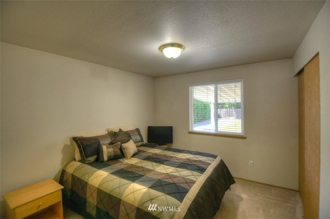 5436 187th Court Southwest Rochester, WA 98579 - Photo 15 of 25 a bed sitting in a bedroom next to a window
