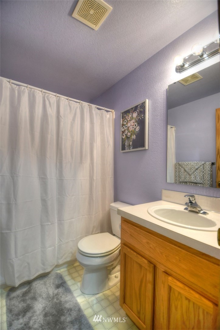 5436 187th Court Southwest Rochester, WA 98579 - Photo 17 of 25 a bathroom with a toilet a sink and a mirror