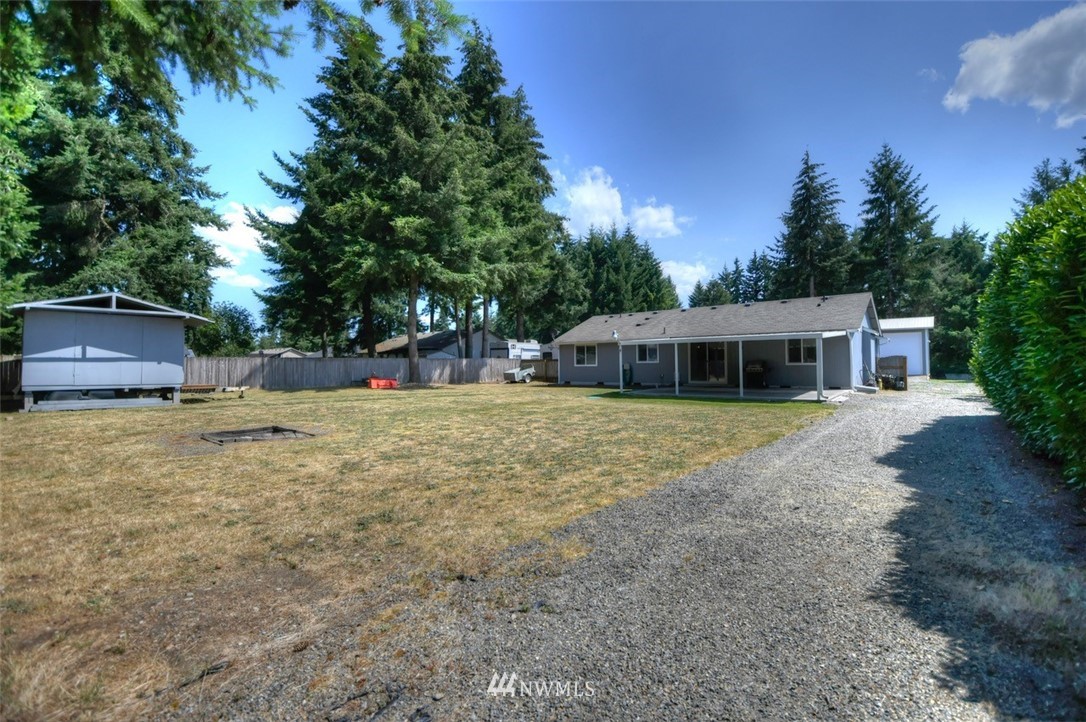5436 187th Court Southwest Rochester, WA 98579 - Photo 21 of 25 a front view of a house with a yard
