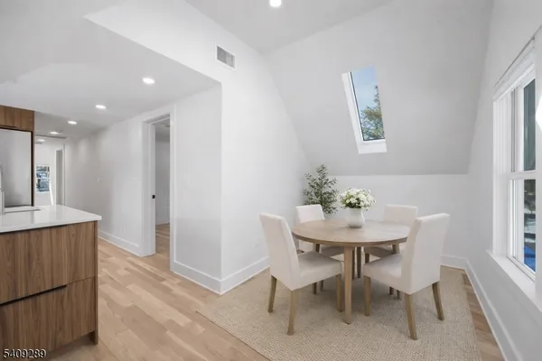 a view of a dining room with furniture and a potted plant