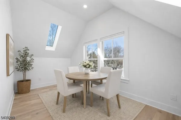 a view of a dining room with furniture and a potted plant
