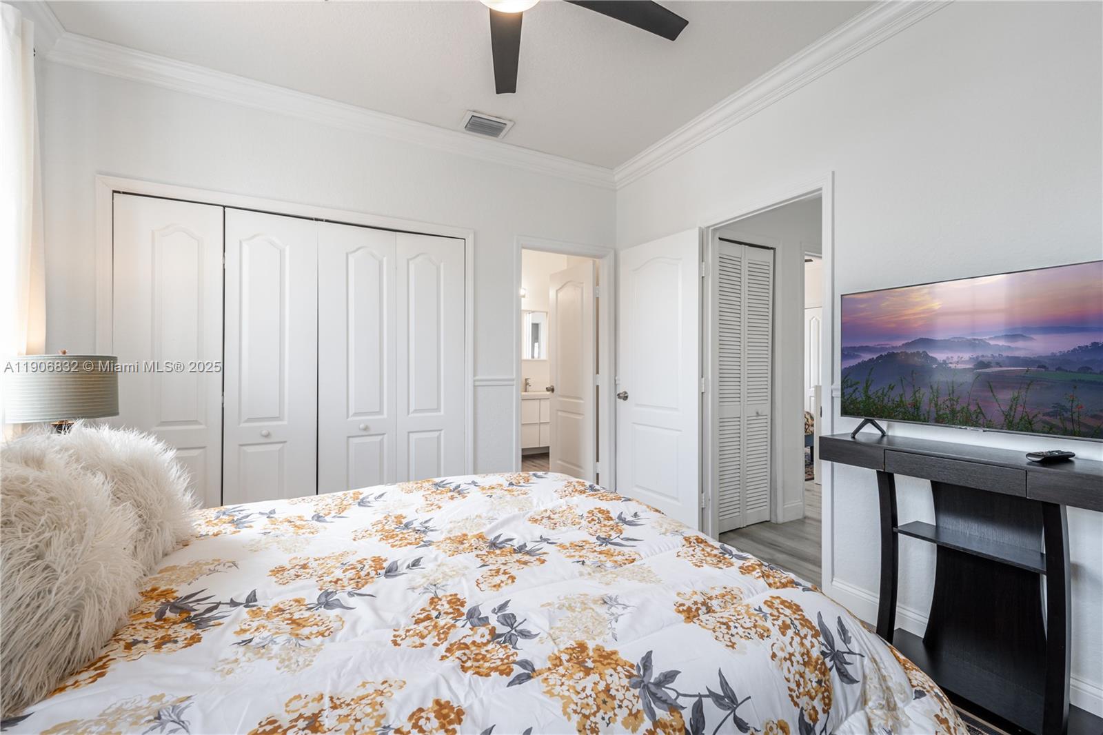 1733 Southwest 151 Place Miami, FL 33185 - Photo 36 of 43 a bedroom with a bed and a flat screen tv