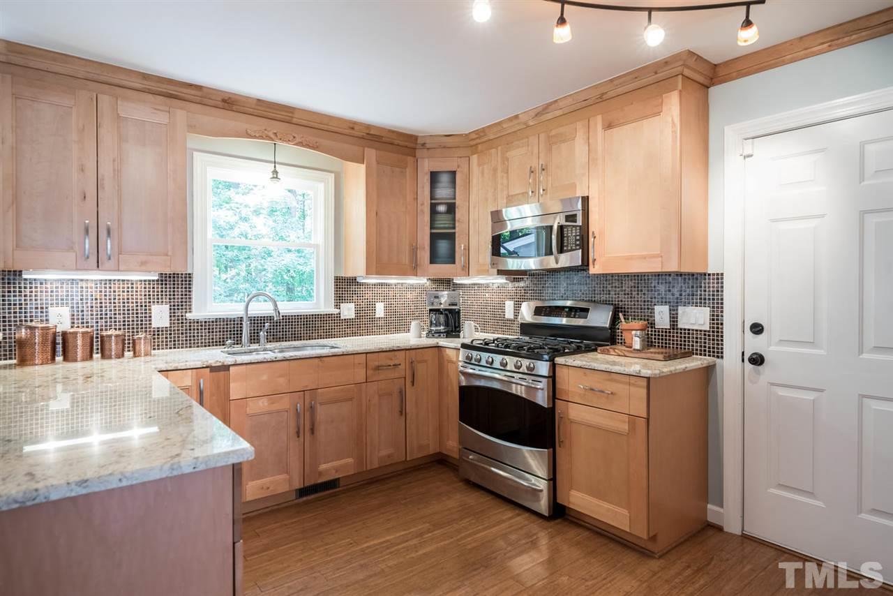 2612 Dahlgreen Road Raleigh, NC 27615 - Photo 11 of 25 a kitchen with stainless steel appliances granite countertop a stove a sink and a microwave