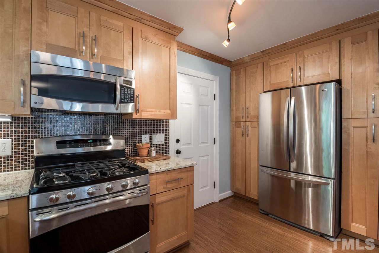 2612 Dahlgreen Road Raleigh, NC 27615 - Photo 13 of 25 a kitchen with granite countertop a refrigerator stove and microwave