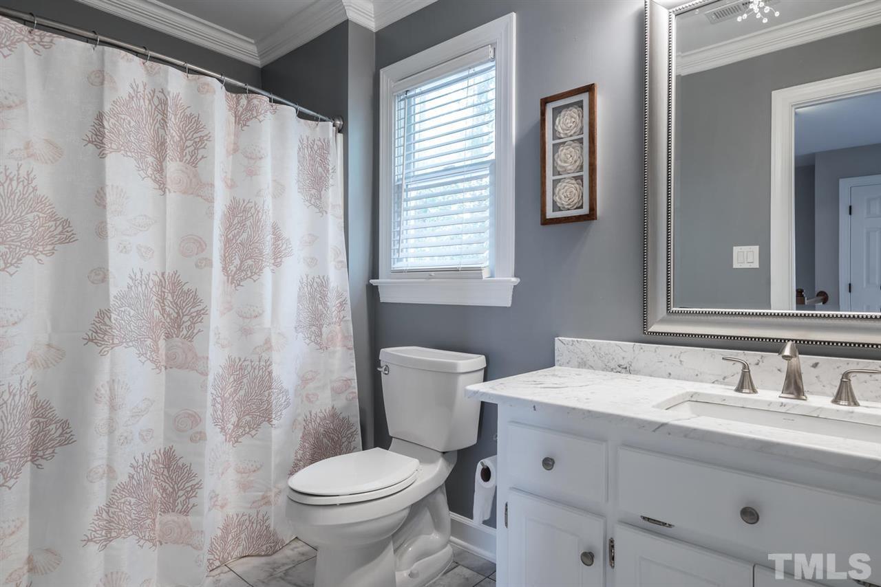 2612 Dahlgreen Road Raleigh, NC 27615 - Photo 19 of 25 a bathroom with a toilet sink and mirror