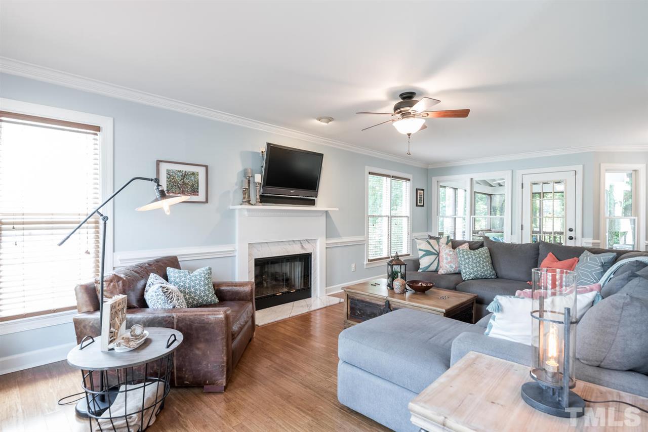 2612 Dahlgreen Road Raleigh, NC 27615 - Photo 6 of 25 a living room with furniture a fireplace and a flat screen tv