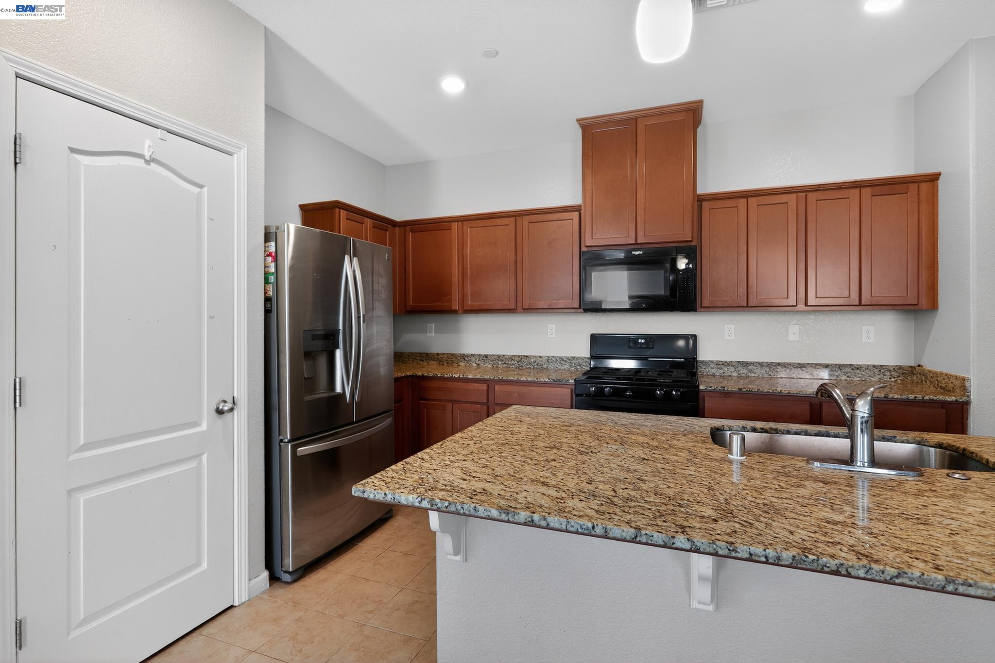 1974 Garden Lane Rio Vista, CA 94571 - Photo 7 of 19 a kitchen with granite countertop a refrigerator and a stove top oven