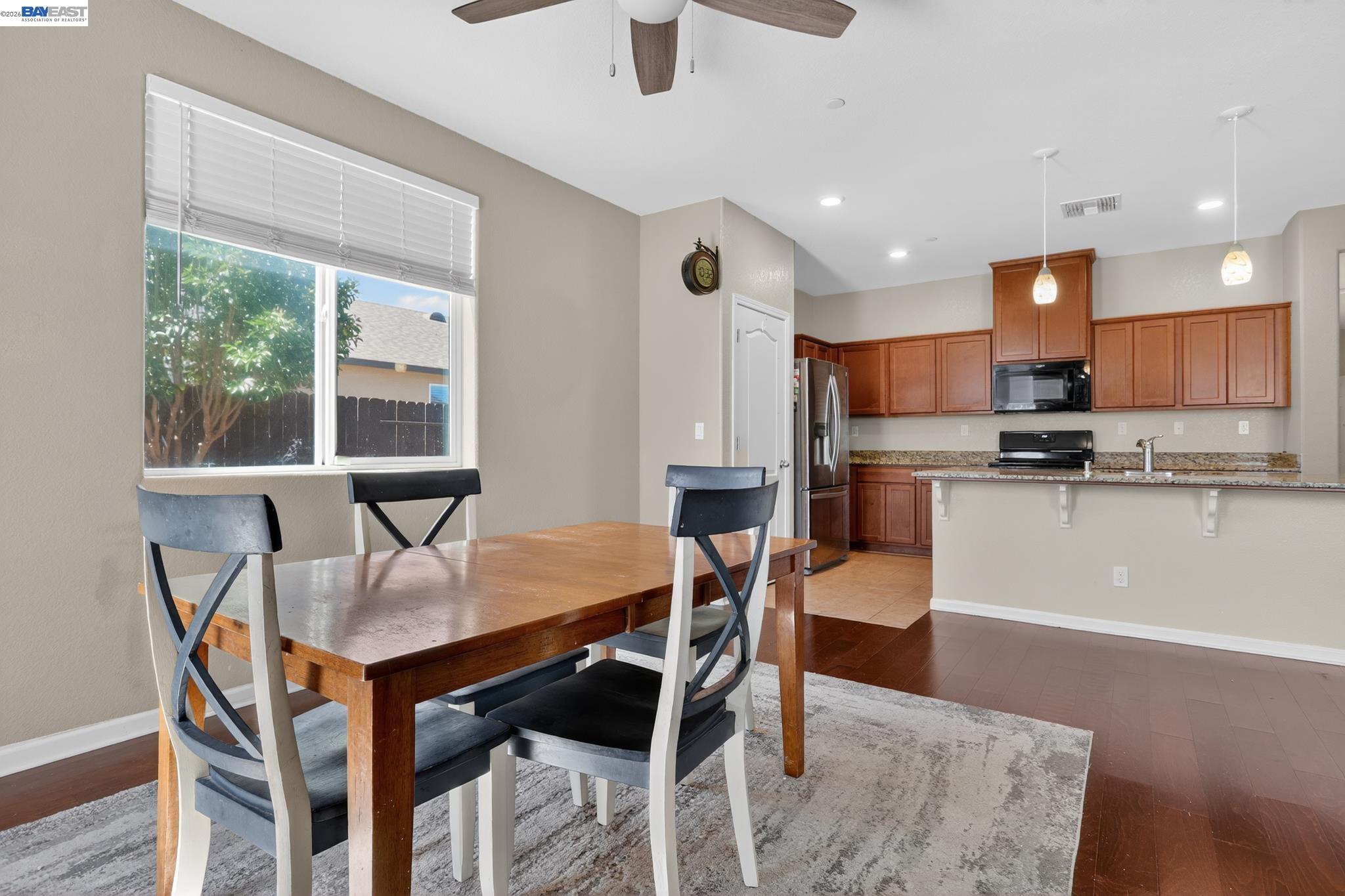 1974 Garden Lane Rio Vista, CA 94571 - Photo 9 of 19 a open dining room with stainless steel appliances kitchen island granite countertop a dining table chairs and a refrigerator