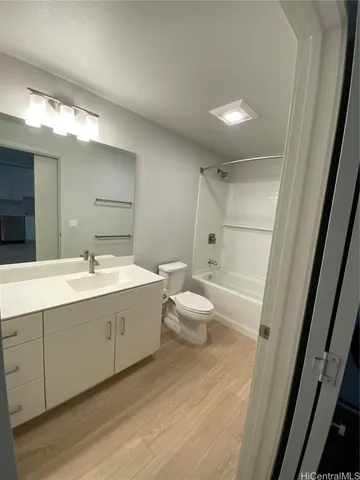 a bathroom with a double vanity sink toilet and shower