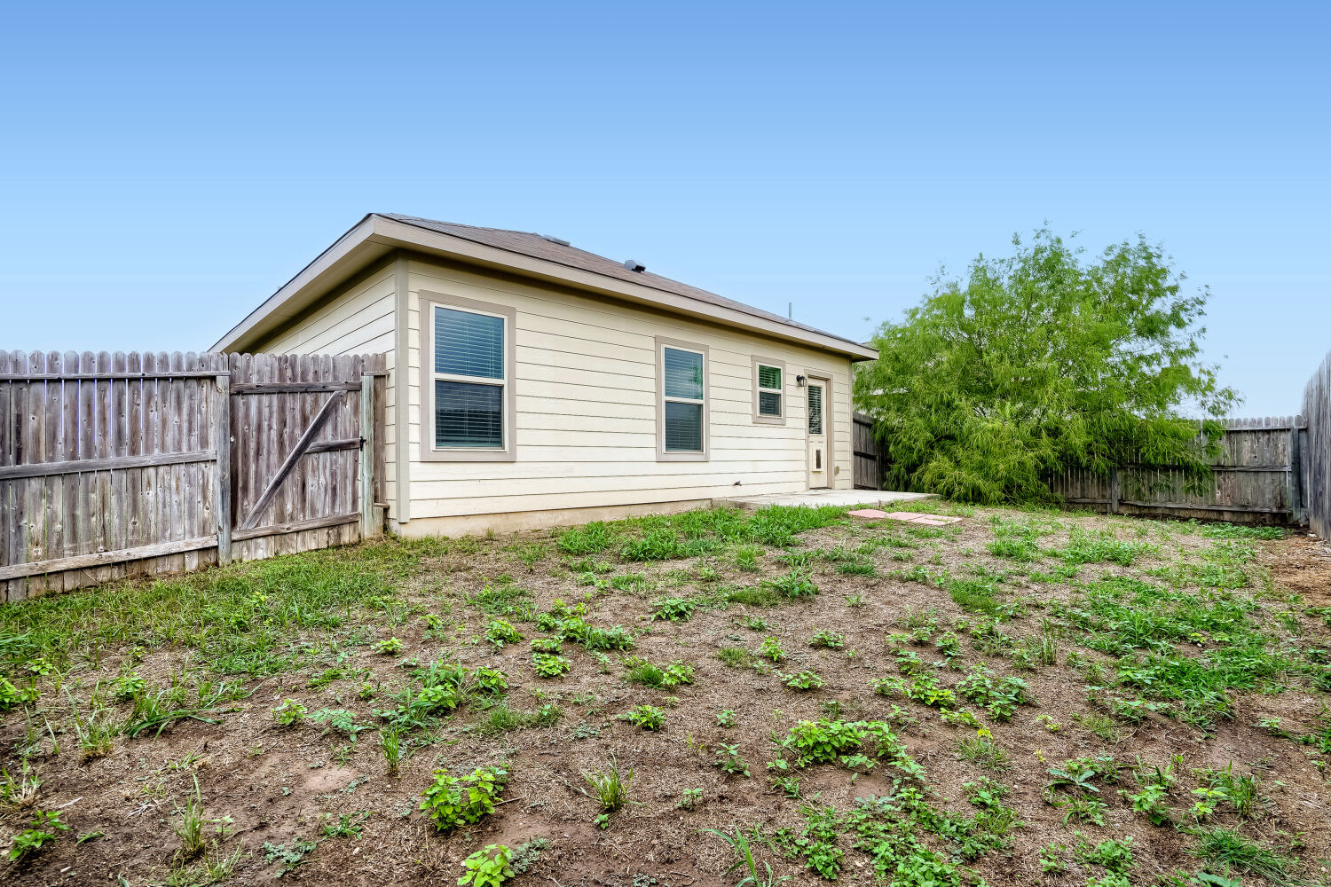 2420 Ranger Pass Seguin, TX 78155 - Photo 26 of 28 Rear exterior featuring horizontal siding, a fenced perimeter, and a concrete patio space