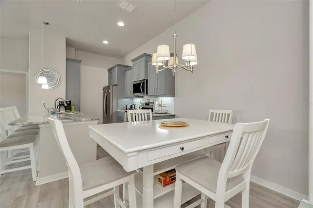 a view of a dining room with furniture and chandelier