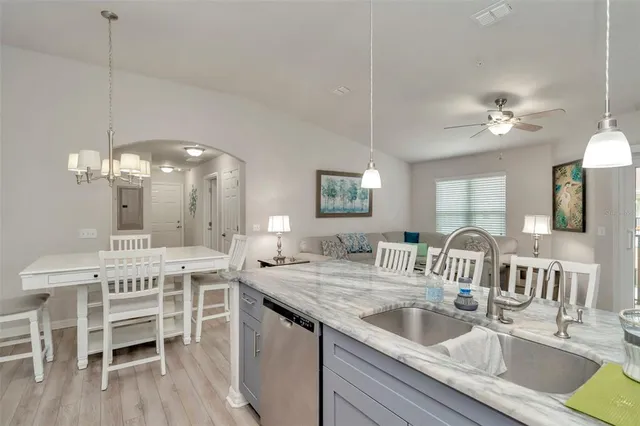 a kitchen with a dining table a sink and dishwasher with kitchen view