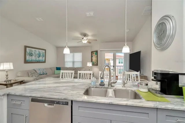 a view of a kitchen with a sink and a mirror