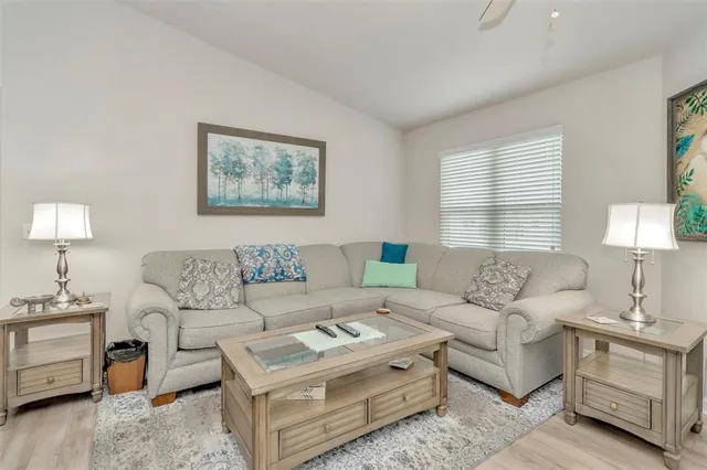 a living room with furniture a lamp and a window