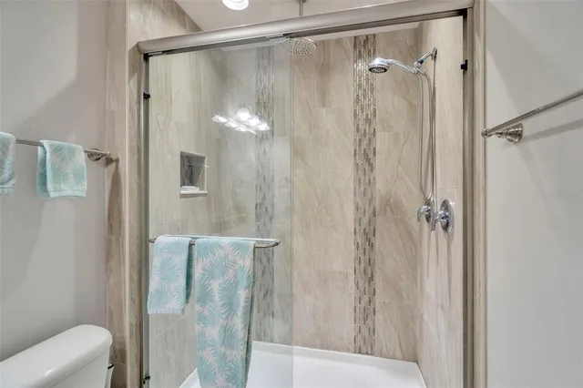 a bathroom with a shower and a mirror